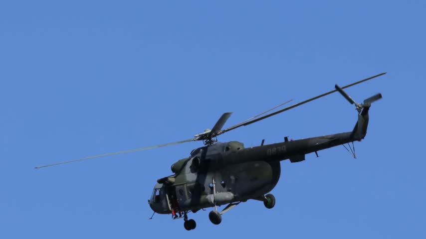 
Mil Mi-17 transport helicopter of the Czech Armed Forces flying across a blue sky