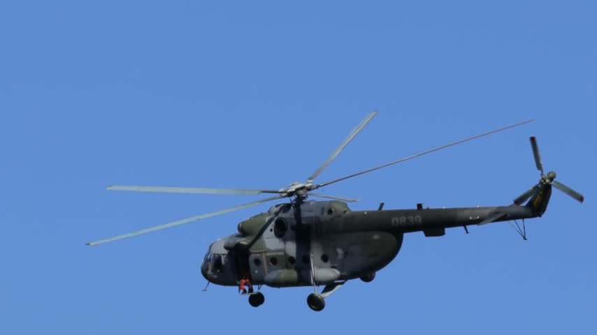 
Mil Mi-17 transport helicopter of the Czech Armed Forces flying across a blue sky