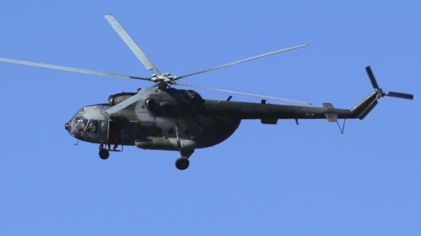 
Mil Mi-17 transport helicopter of the Czech Armed Forces flying across a blue sky