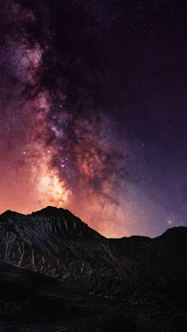 Night landscape, snow covered mountains under milky way galaxy. Space cosmos.