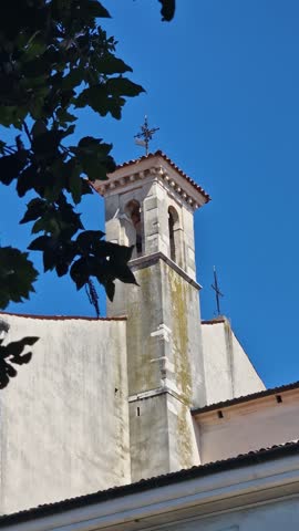 Vertical View of Catholic Church Bell Tower on Sunny Summer Day
