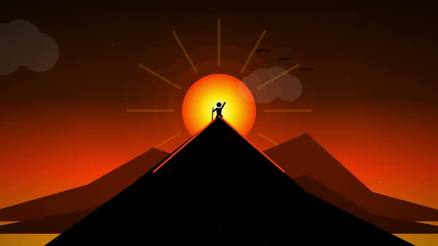 Silhouette of a hiker standing on a mountain peak during a golden sunset