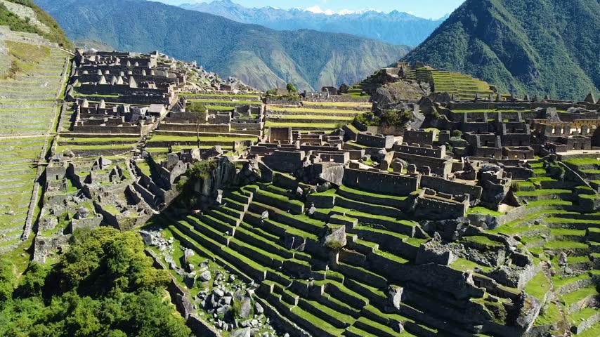 Majestic view of the famous machu picchu inca citadel in peru. Moving shadows highlighting the ancient ruins, agricultural terraces and mountains