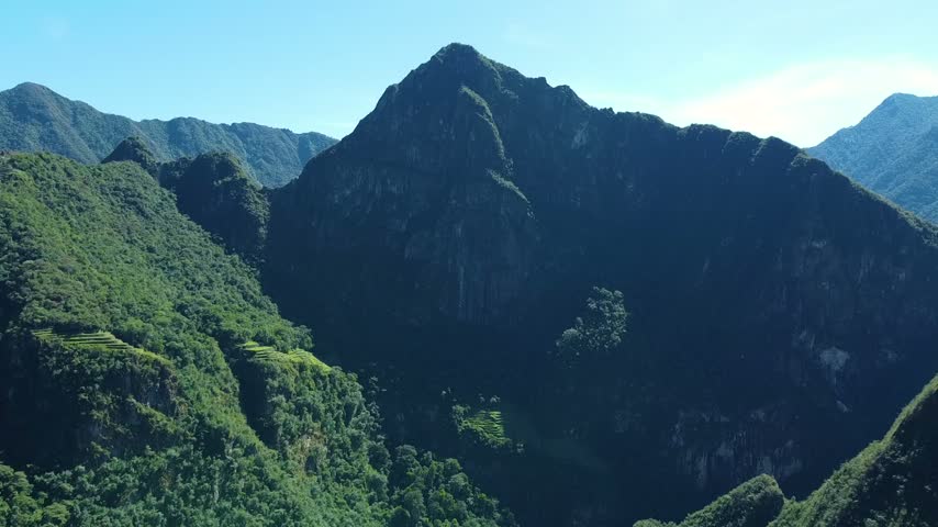 Stunning aerial footage revealing the ancient inca terraces built into the green slopes of the majestic machu picchu mountain in peru
