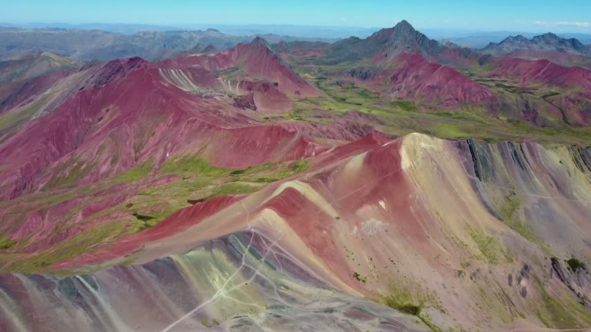 Aerial flying over the vinicunca, or montana de siete colores, a colorful mountain range in the andes of peru near cusco