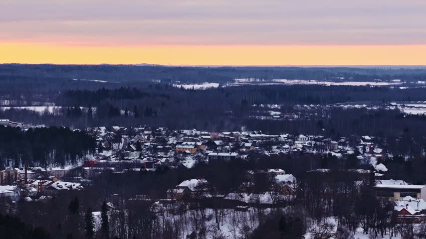 Aerial view of a small town covered in snow during a beautiful winter morning sunrise