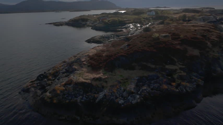 Aerial footage over the Norwegian Sea approaching a wrecked ship near the Atlantic Ocean Road in Norway, revealing the vessel and surrounding coastal waters.