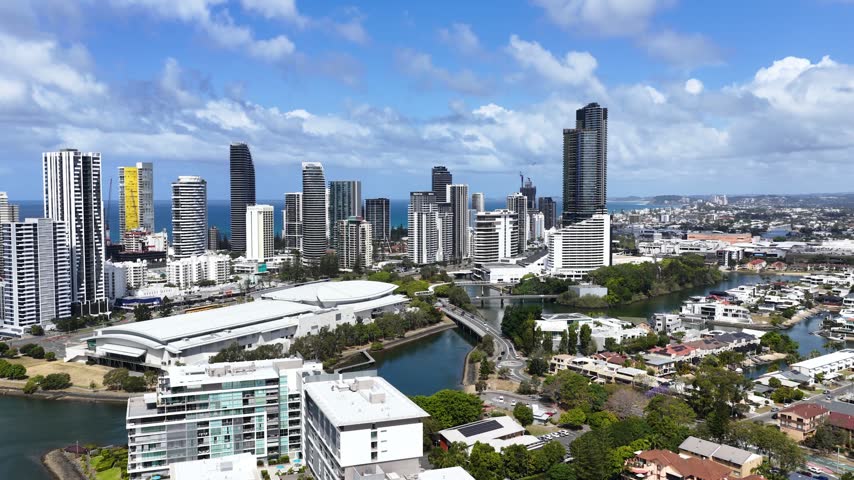Aerial wide shot of the Gold Coast skyline, waterways, and urban waterfront in Queensland, Australia.