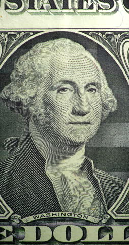 George Washington portrait stop motion animation. Portrait on one dollar bill moves through stop motion animation. George Washington engraved face changes position within printed currency design.