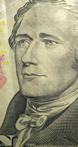 Alexander Hamilton portrait stop motion animation. Portrait on ten dollar bill moves through stop motion animation. Alexander Hamilton engraved face changes position within printed currency design.