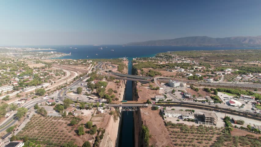 Aerial view of the Isthmus of Corinth with its narrow canal and bridges crossing the landscape in Corinth, Greece.