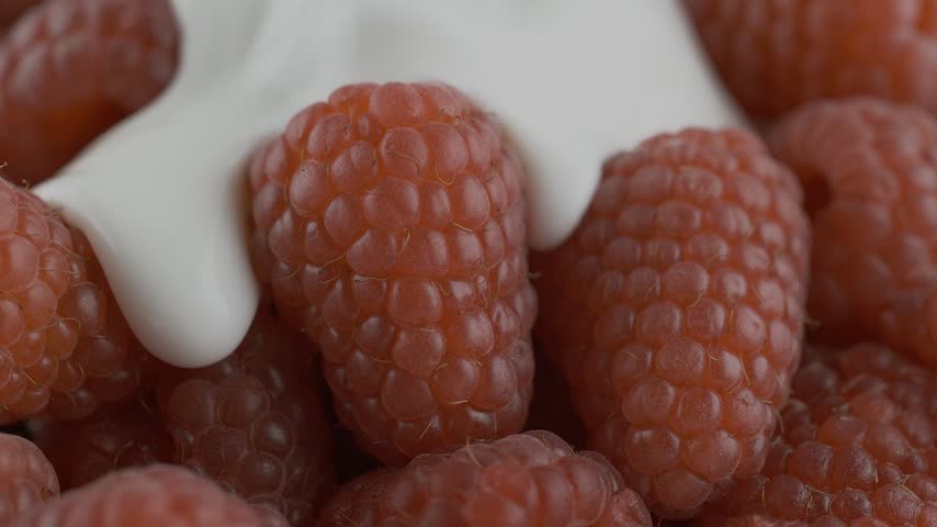 A horizontal composite shows raspberries dripping with white cream captured in a detailed close-up. The vibrant red fruit and smooth