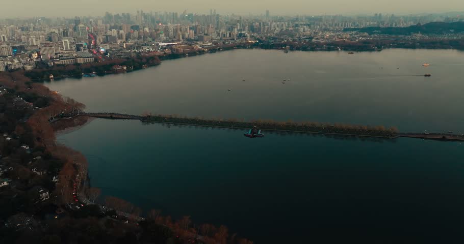 Aerial view of West Lake and sprawling Hangzhou skyline at dusk