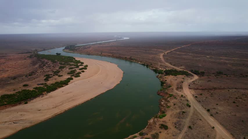 Aerial view of Galana River winding through the arid landscape of Tsavo East, Tana River County, Kenya.