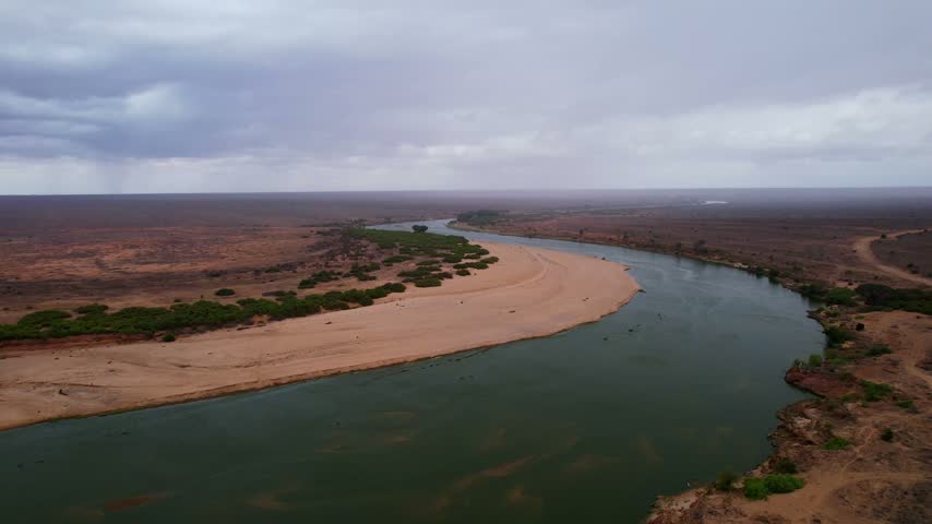 Aerial view of Galana River flowing through the arid landscape of Tsavo East, Tana River County, Kenya.