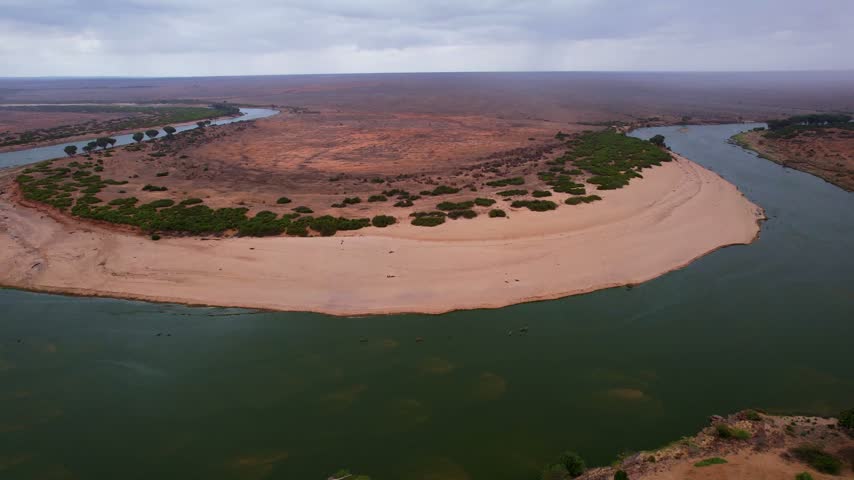 Aerial view of Galana River winding through the arid landscape of Tsavo East, Tana River County, Kenya.