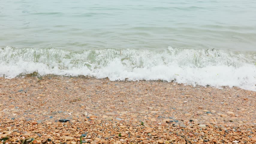Waves are washing onto the sandy beach.