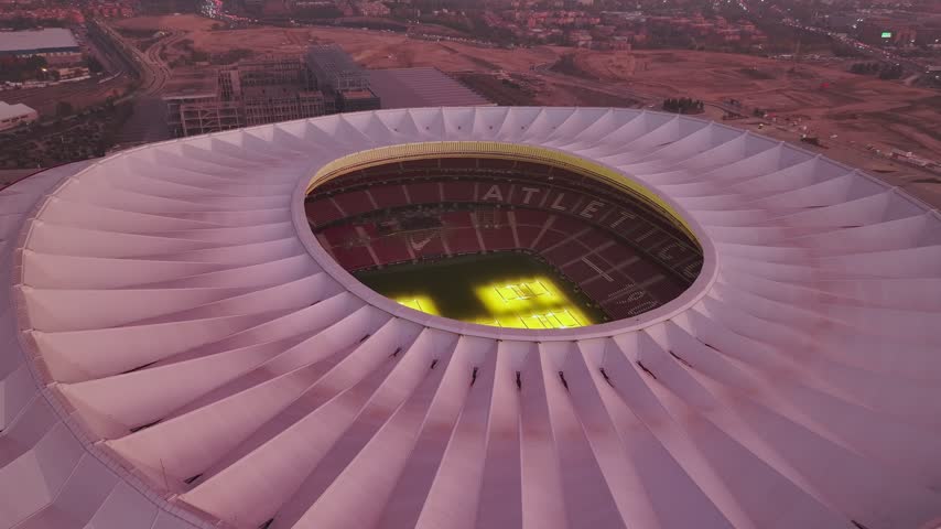 Aerial view of Riyadh Air Metropolitano Stadium with its distinctive roof structure and illuminated pitch in Madrid, Comunidad de Madrid, Spain.