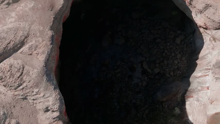 Oregon coastline aerial view showcasing a large natural sinkhole surrounded by dramatic rocky cliffs and turquoise ocean water