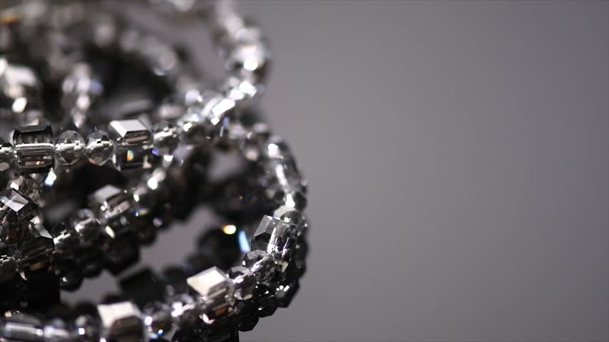 Crystals bracelet or necklace border jewels, gems, diamonds over black background, beautiful gems, rhinestones, brilliants sparkling with colorful caustics, rainbow lights. Moissanite. Zirconia 