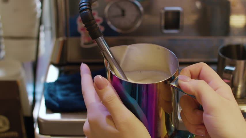 Barista Steaming Milk in Metal Pitcher