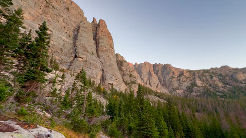 low Angle Drone View of Granite Rock Spires and Hiking Trail at Sunset in Rocky Mountain National Park