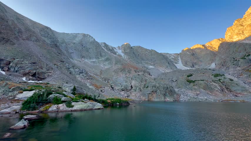aerial View of Alpine Lake with Golden Sunrise Light on Mountain Peaks in Rocky Mountain National Park