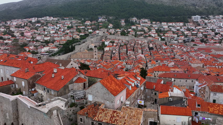 Aerial Reveal Shot of the Coastal Historic City of Dubrovnik and its Harbour in Croatia