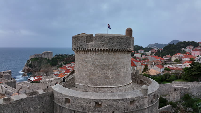 Aerial Drone Footage of the national flag on top of a Castle of a Historic and Fortified City of Dubrovnik, in Croatia