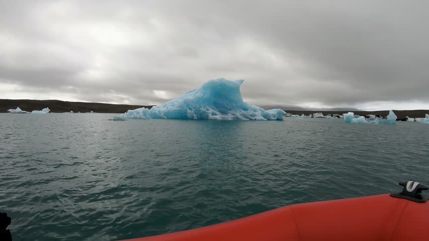 Boat trip cruise among melting icebergs as result of global warming. Jokulsarlon, Iceland