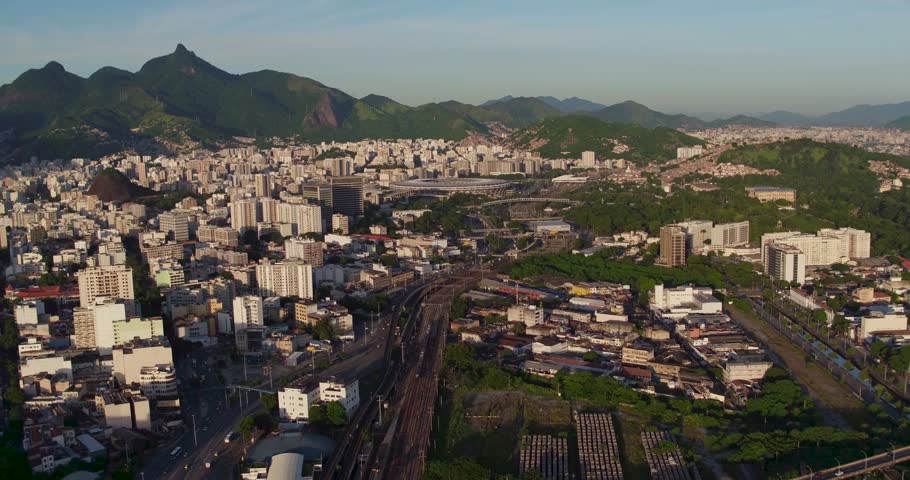Aerial view of the urban landscape of Rio de Janeiro, featuring dense buildings, winding roads, and lush green mountains in Rio de Janeiro, Rio de Janeiro, Brazil.