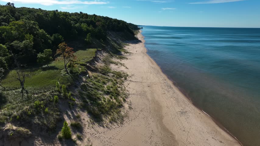 Steady aerial with drone over the lakeshore of Lake Michigan.