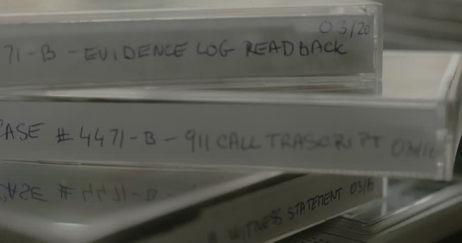 Close-up slide shot reveals cassette tapes displayed on a detective board as archived evidence for a retro cold case investigation.