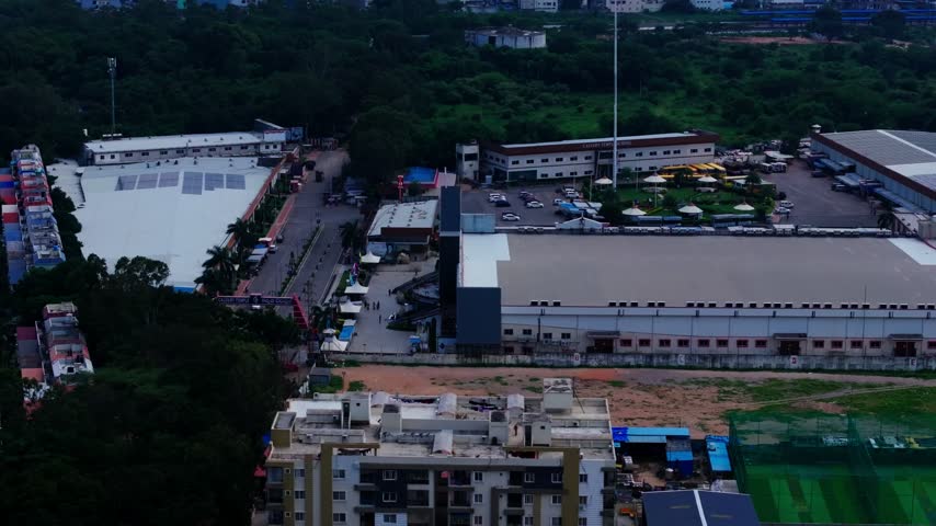 Calvary Temple with parking area, trees and villas at hafeezpet, miyapur, hyderabad, telangana, india. day time, arc shot, drone shot, 4k.