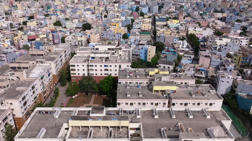 Bird eye view of Silver Springs Apartments with terrace, low-rise buildings and flying birds at chinthal, quthbullapur, hyderabad, telangana, india. day time, crane shot, drone shot, 4k.