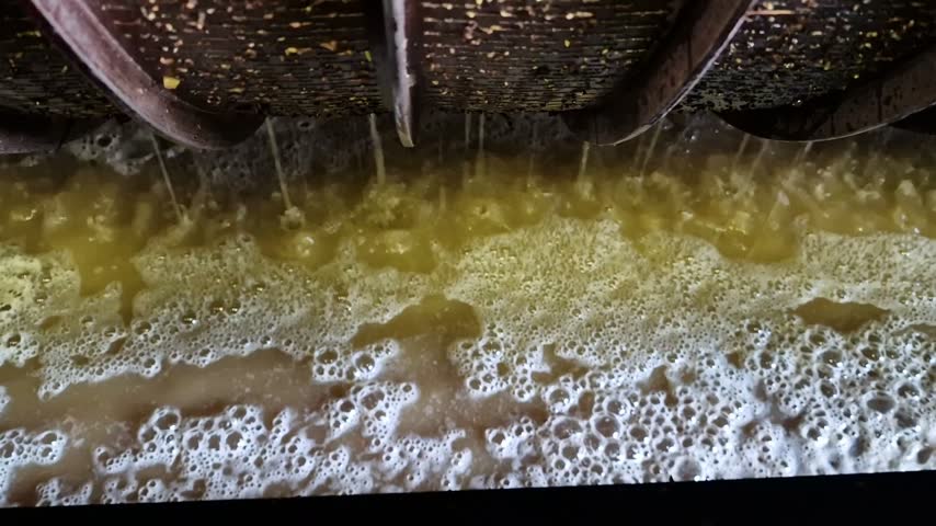 Winemaking in South Moravia, Czech Republic, showing wine filtration and the separation of solid particles from young wine during production.