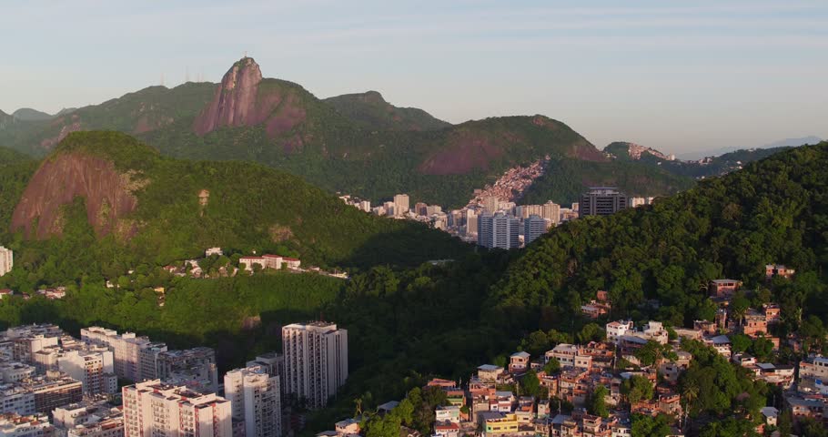 Aerial view of the lush mountains and urban landscape of Rio de Janeiro with Corcovado mountain in the distance, Rio de Janeiro, Rio de Janeiro, Brazil.