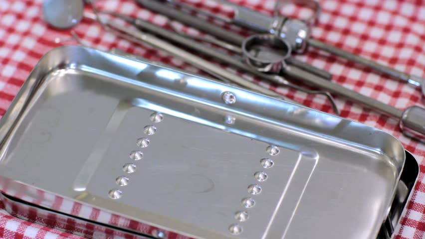 closeup view of a hand and dental instruments