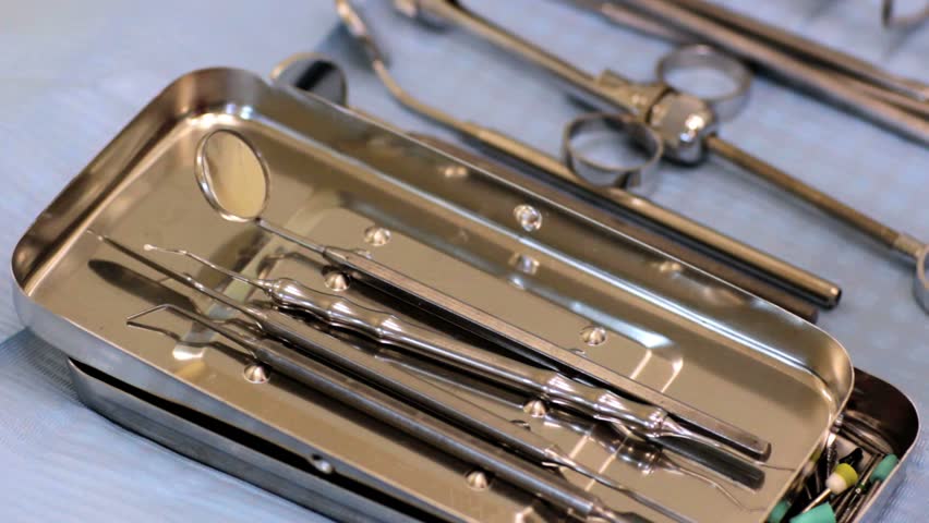 Dentist working, closeup view of a hand and dental instruments