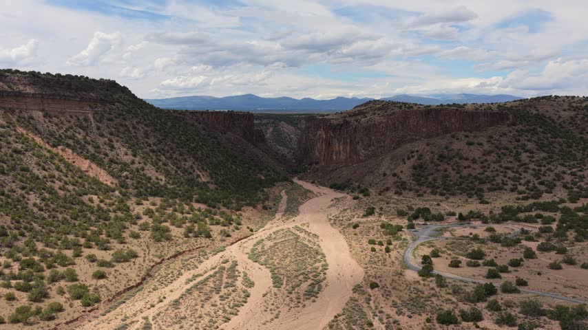 Aerial view of the rugged landscape of Diablo Canyon Recreation Area with steep canyon walls, dry riverbed, and desert vegetation in Santa Fe, New Mexico, United States.