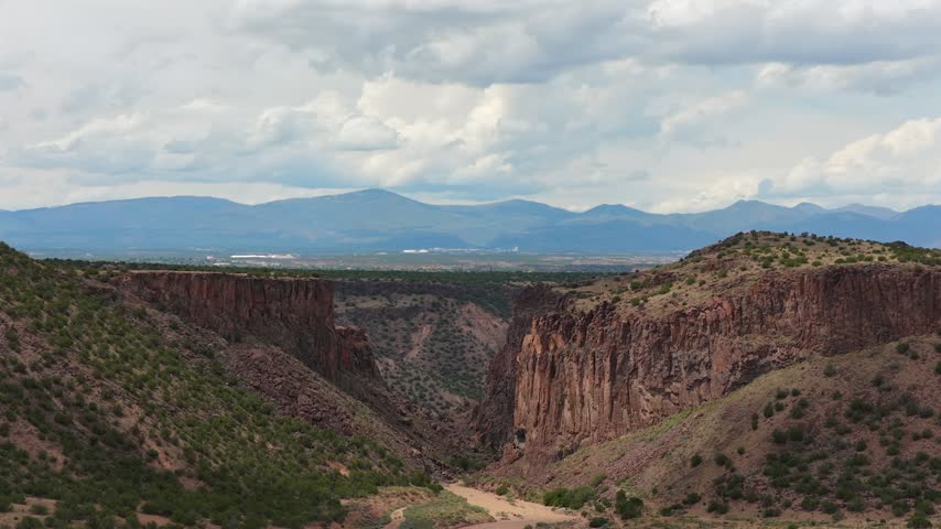 Aerial view of the rugged red rock cliffs and desert landscape of Diablo Canyon Recreation Area in Santa Fe, New Mexico, United States.