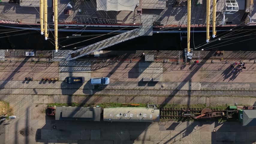 Top down view rising from the museum quay with old railway wagons to the deck of the four-masted barque Peking in Hamburg, Germany, long shadows in low sunlight