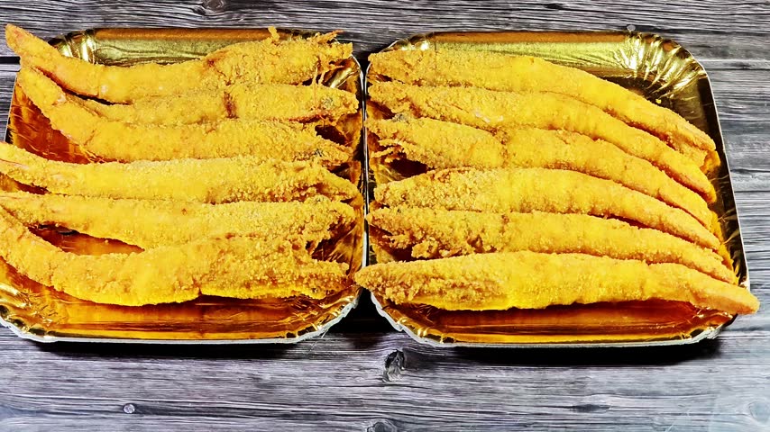 Two disposable plates of crispy deep-fried shrimps, Breaded and fried seafood, Golden-brown and crunchy coating shrimp fried as a whole with head and tail