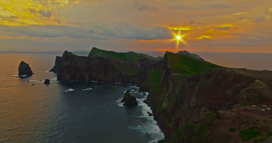 Aerial view at incredibly beautiful sunrise over the rocky coast of the island in the Atlantic Ocean, the western tip of the Sao Lourenco peninsula, Madeira, Portugal