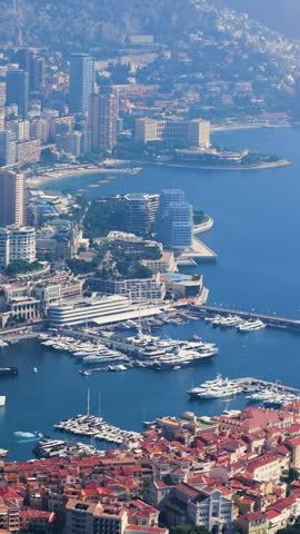 Stunning aerial perspective showing the densely populated cityscape of Monaco, including the old town and the famous Port Hercules filled with yachts