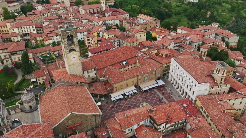 Aerial drone view of Piazza del Duomo in Bergamo, Italy, showcasing the historic square, Bergamo Cathedral, Basilica di Santa Maria Maggiore, medieval architecture, and Città Alta.