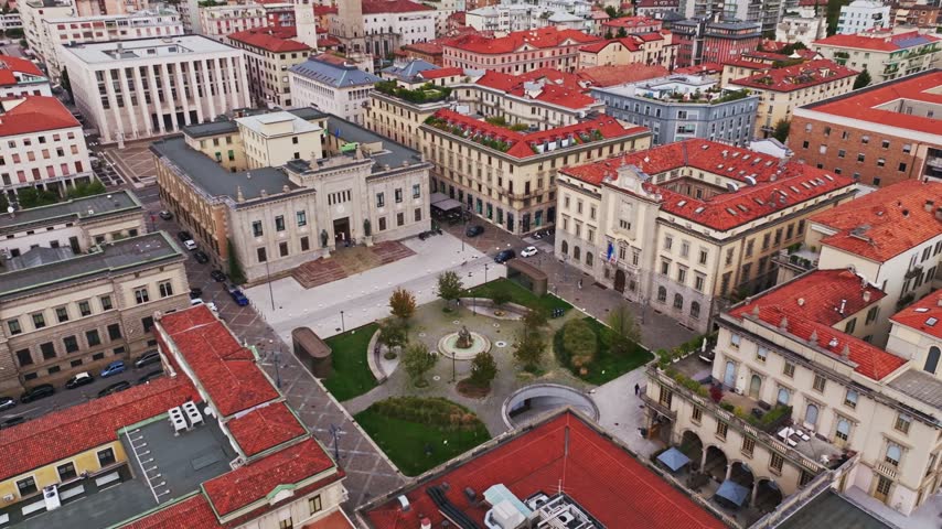 Aerial drone view of Piazza Dante Alighieri in Bergamo, Italy, showcasing the urban square, surrounding historic architecture, city streets, and vibrant cityscape of Lombardy.