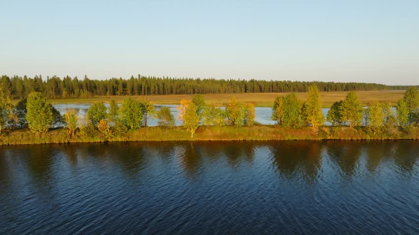 Aerial view of the river and tree-lined banks in Peurasuvanto, Lappi, Finland.