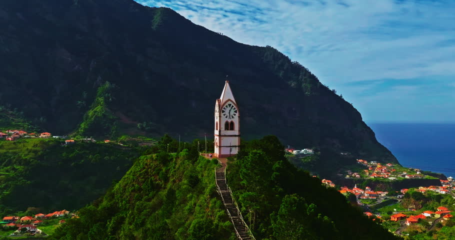 Aerial view of a beautiful chapel in the very picturesque village of Sao Vicente on the island of Madeira, situated on a hillside in a lovely green valley by the Atlantic Ocean