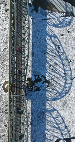 Bridge with traffic over a frozen river with ice floes. Aerial view on winter in Poland.